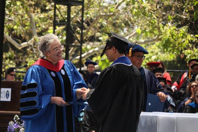 President G. Gabrielle Starr congratulates one of the members of the graduating Class of 2023.