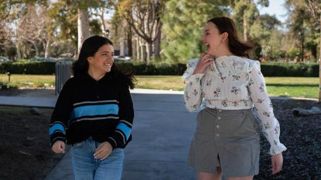 Pomona College students take a stroll through campus in the fall.